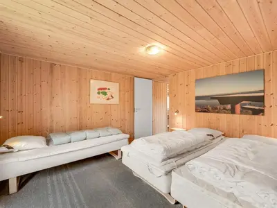 two beds in a room with wooden walls at Holiday Home Scarlet - 400m to the fjord by Interhome in Vinderup