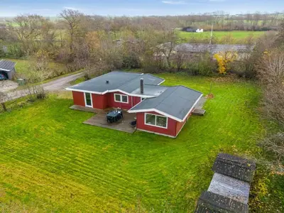 an aerial view of a red house on a yard at Holiday Home Scarlet - 400m to the fjord by Interhome in Vinderup