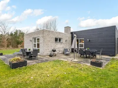 a patio with a table and chairs in front of a house at Holiday Home Jarven - 500m to the fjord by Interhome in Højslev