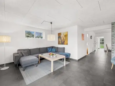 a living room with a couch and a table at Holiday Home Jarven - 500m to the fjord by Interhome in Højslev