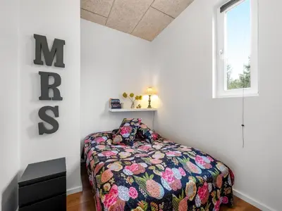 a bedroom with a bed in a white room at Holiday Home Tenna - 250m to the fjord by Interhome in Højslev