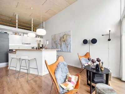 a kitchen and living room with a table and chairs at Holiday Home Tenna - 250m to the fjord by Interhome in Højslev