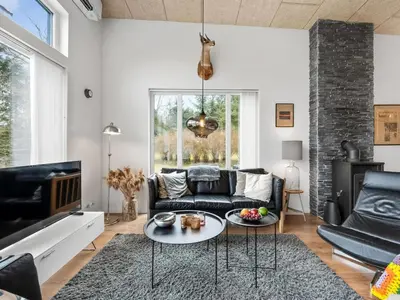 a living room with a couch and a table at Holiday Home Tenna - 250m to the fjord by Interhome in Højslev