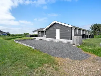 a house with a gravel driveway in front of it at Holiday Home Nahel - 150m to the fjord by Interhome in Vinderup