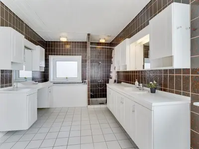 a white bathroom with two sinks and a tub at Holiday Home Rahild - 2km to the fjord by Interhome in Thyholm