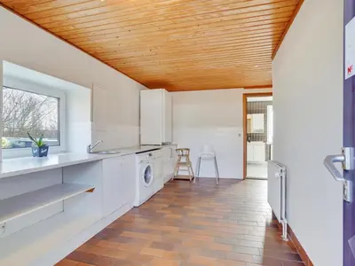 a kitchen with white appliances and a wooden ceiling at Holiday Home Rahild - 2km to the fjord by Interhome in Thyholm