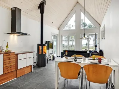 a kitchen with a table and chairs in a room at Holiday Home Angelita - 80m to the fjord by Interhome in Thyholm