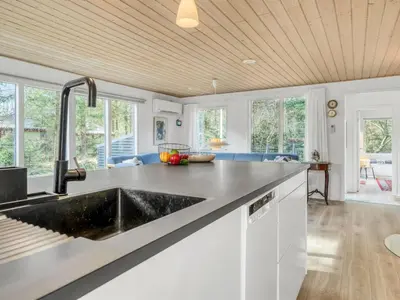 a kitchen with white cabinets and a sink at Holiday Home Milan - 250m to the fjord by Interhome in Thyholm