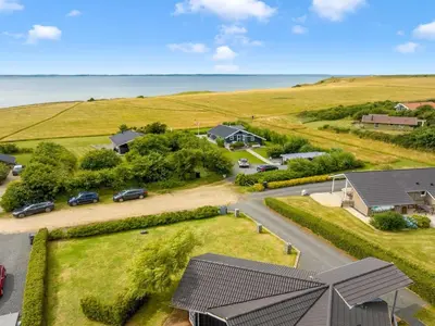 an aerial view of a house with the ocean in the background at Holiday Home Eberta - 200m to the fjord by Interhome in Vinderup