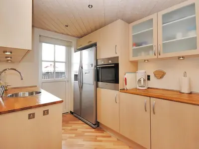 a kitchen with a sink and a refrigerator at Holiday Home Eberta - 200m to the fjord by Interhome in Vinderup