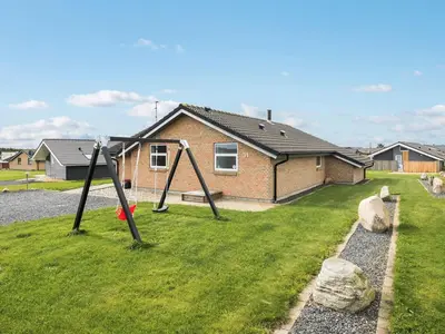 a swing set in a yard in front of a house at Holiday Home Alboldus - 250m to the fjord by Interhome in Vinderup