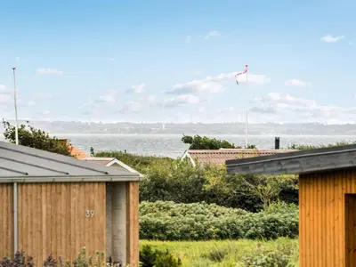 a view of the ocean from the roofs of houses at Holiday Home Alboldus - 250m to the fjord by Interhome in Vinderup