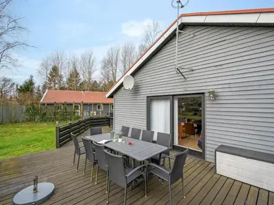 a patio with a table and chairs on a deck at Holiday Home Anine - 200m to the fjord by Interhome in Højslev