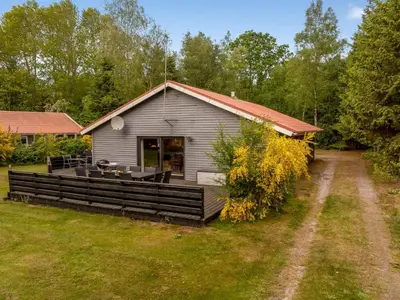 a house with a deck in the yard at Holiday Home Anine - 200m to the fjord by Interhome in Højslev