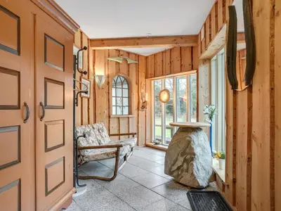 a hallway with a door and a chair in a room at Holiday Home Flugha - 500m to the fjord by Interhome in Thyholm