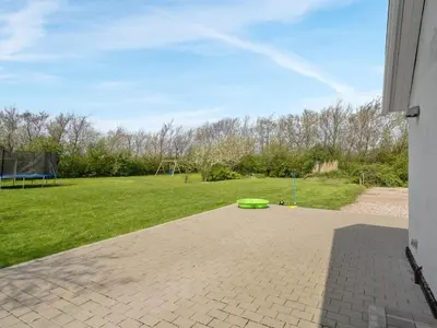 a green frisbee sitting on a brick patio at Holiday Home Folkar - 3km to the fjord by Interhome in Thyholm