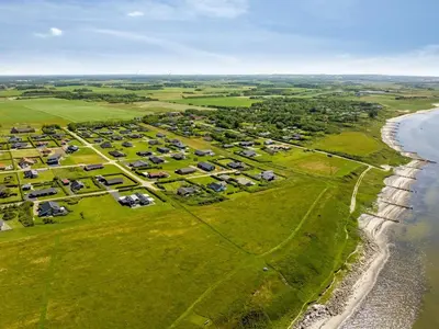 an aerial view of a farm next to the ocean at Holiday Home Samuil - 300m to the fjord by Interhome in Vinderup