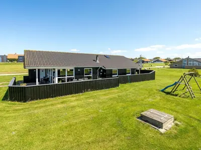 a house with a fence and a grass yard at Holiday Home Samuil - 300m to the fjord by Interhome in Vinderup