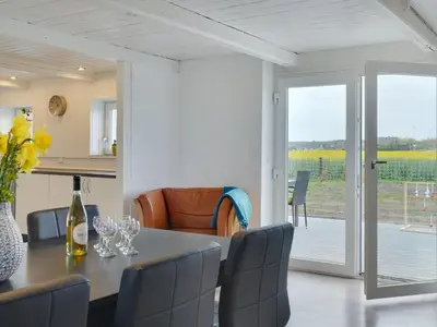 a kitchen and dining room with a table and chairs at Holiday Home Ailke - 2km to the fjord by Interhome in Thyholm