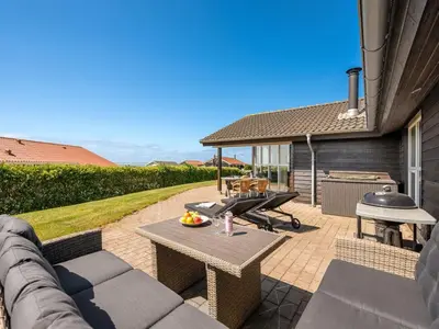 a patio with a picnic table and a grill at Holiday Home Guthmar - 350m to the fjord by Interhome in Vinderup