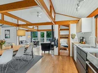 a kitchen and dining room with a table and chairs at Holiday Home Gudfast - 300m to the fjord by Interhome in Thyholm