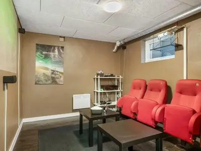 a waiting room with red chairs and a table at Holiday Home Gudfast - 300m to the fjord by Interhome in Thyholm