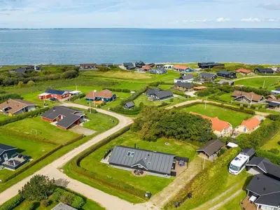 an aerial view of a small town with houses and the ocean at Holiday Home Naninja - 300m to the inlet by Interhome in Vinderup