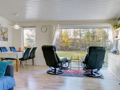 a living room with chairs and a table and a window at Holiday Home Calli - 400m to the fjord by Interhome in Højslev