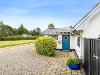 a house with a blue door and a fence at Holiday Home Aliza - 300m to the fjord by Interhome in Roslev