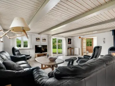 a living room with a couch and chairs and a table at Holiday Home Aliza - 300m to the fjord by Interhome in Roslev