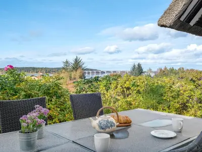 a table with a basket of bread on it at Holiday Home Tordis - 250m to the fjord by Interhome in Roslev