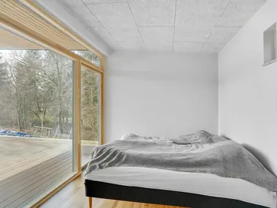 a bedroom with a bed and a large window at Holiday Home Haubert - 500m to the fjord by Interhome in Lihme