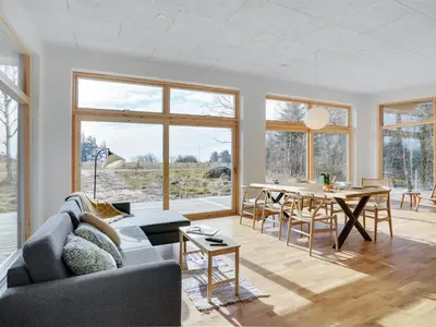 a living room with a couch and a table at Holiday Home Haubert - 500m to the fjord by Interhome in Lihme