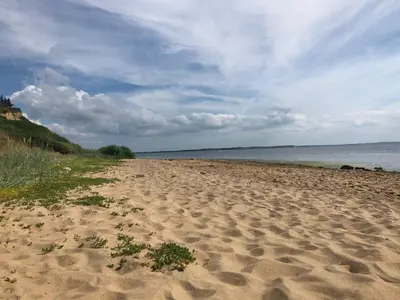 a sandy beach with a view of the ocean at Holiday Home Heera - 100m to the fjord by Interhome in Lihme