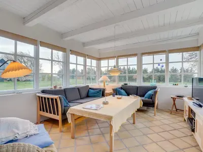 a living room with a couch and a table at Holiday Home Althea - 750m to the fjord by Interhome in Fur