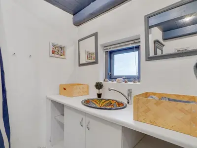 a bathroom with a sink and a mirror at Holiday Home Althea - 750m to the fjord by Interhome in Fur