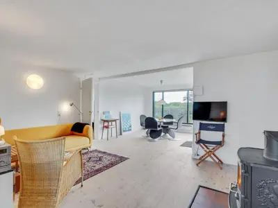 a living room with a yellow couch and a tv at Holiday Home Lok - 90m to the fjord by Interhome in Roslev