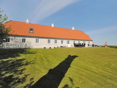 a long shadow of a house with an orange roof at Holiday Home Alois - 1km to the fjord by Interhome in Hesselbjerg