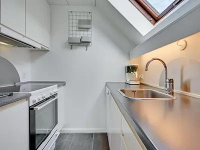 a kitchen with a sink and a window at Holiday Home Femija - 500m to the fjord by Interhome in Roslev