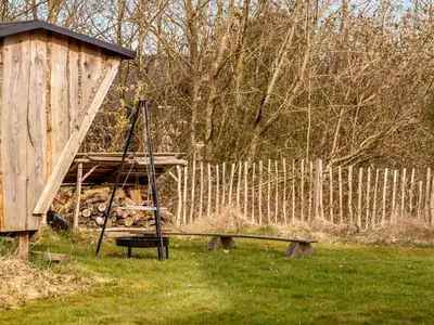 a wooden out house with a bench and a swing at Holiday Home Thyra - 500m to the fjord by Interhome in Fur