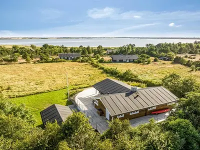 an overhead view of a house with a field and water at Holiday Home Eljas - 200m to the fjord by Interhome in Fur