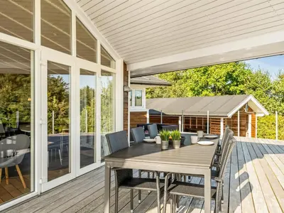 a patio with a table and chairs on a deck at Holiday Home Eljas - 200m to the fjord by Interhome in Fur