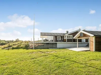 a house with a green field in front of it at Holiday Home Eljas - 200m to the fjord by Interhome in Fur