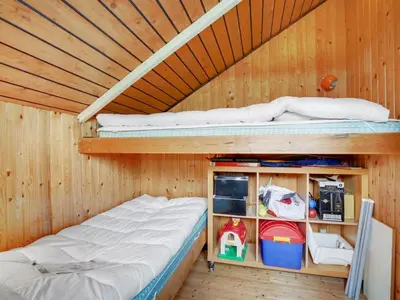 a bedroom with two bunk beds in a wooden room at Holiday Home Henrieke - 250m to the fjord by Interhome in Roslev