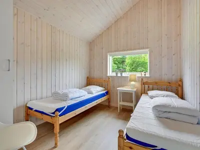 a bedroom with two beds and a window at Holiday Home Regni - 300m to the fjord by Interhome in Nykøbing Mors