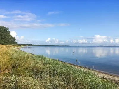 a view of a body of water with a shoreline at Holiday Home Regni - 300m to the fjord by Interhome in Nykøbing Mors