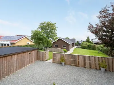 a wooden fence in front of a house at Holiday Home Regni - 300m to the fjord by Interhome in Nykøbing Mors