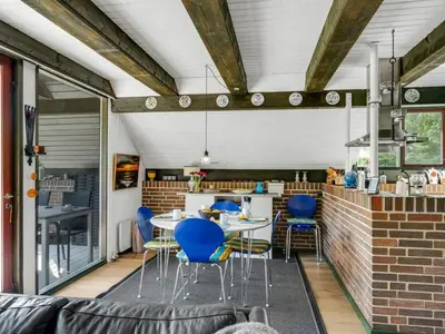 a kitchen and dining room with blue chairs and tables at Holiday Home Paale - 200m to the fjord by Interhome in Fur