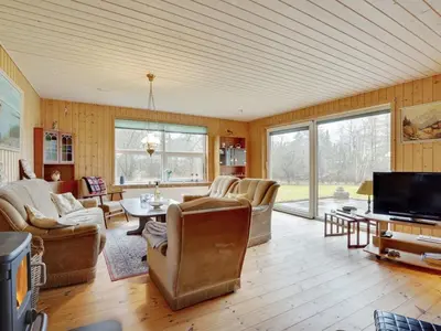 a living room with couches and a tv at Holiday Home Tille - 700m to the fjord by Interhome in Roslev