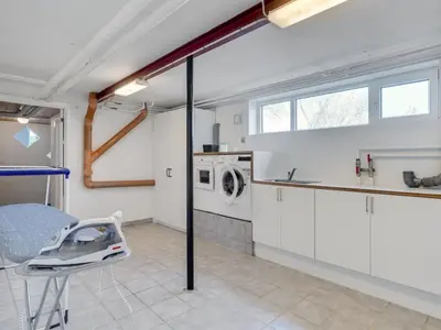 a kitchen with white cabinets and a washing machine at Holiday Home Auguste - 1-5km to the fjord by Interhome in Fur